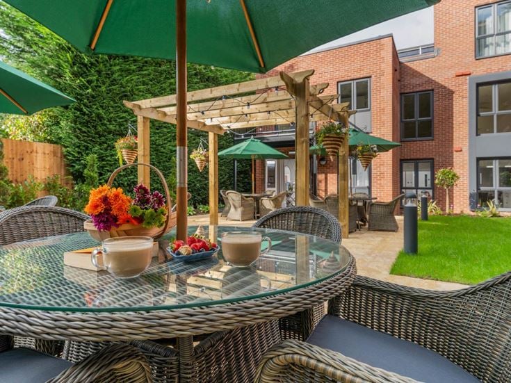 a table with a flower pot and umbrella on it