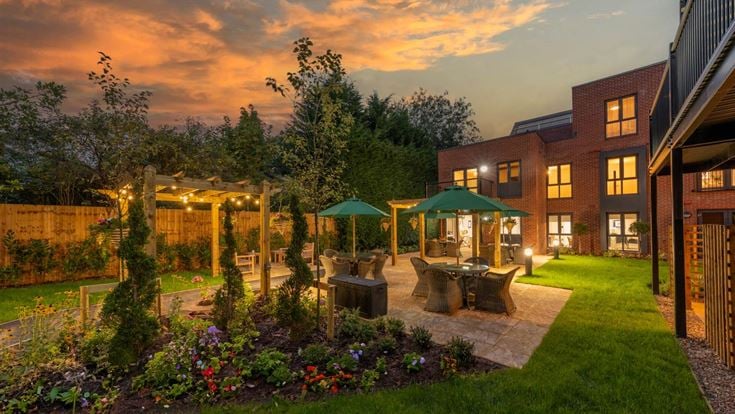 a backyard with a fountain and a garden