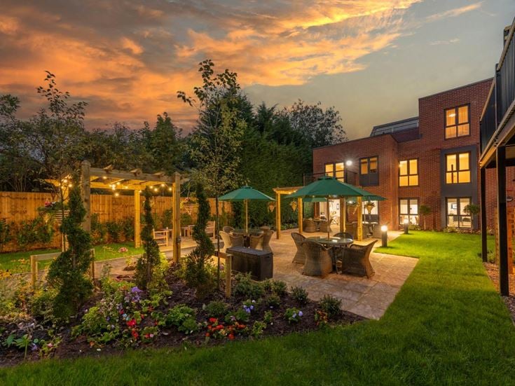 a backyard with a fountain and a garden
