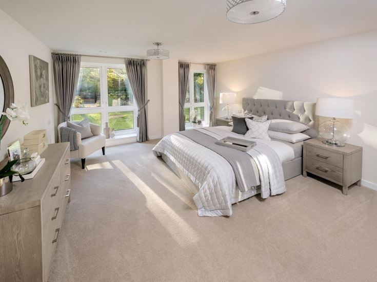 a bedroom with a bed and a chair