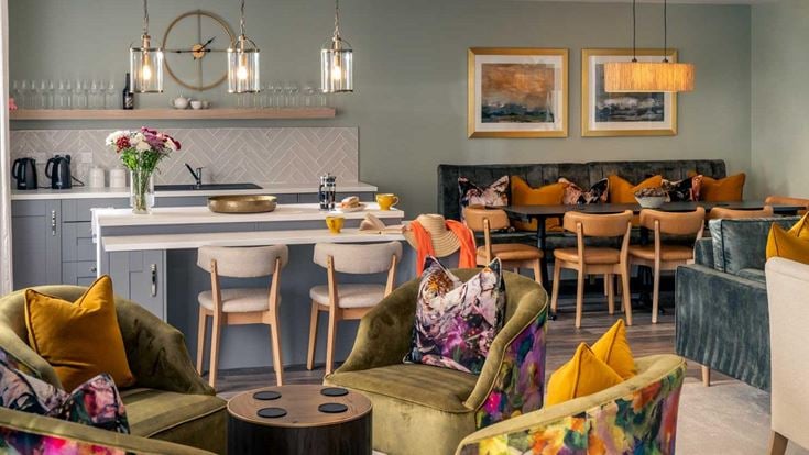 a living room with a kitchen and dining area