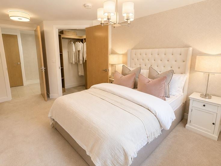 a bedroom with a bed and lamps