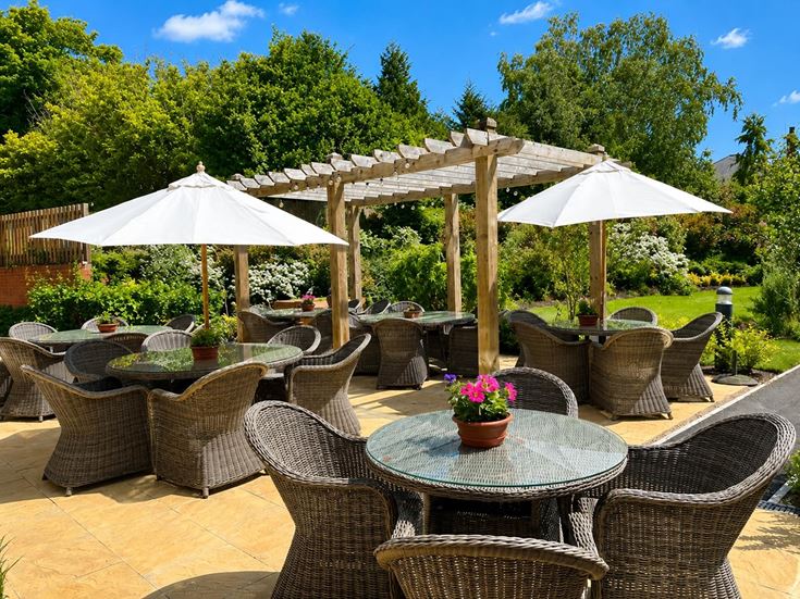 a patio with tables and chairs