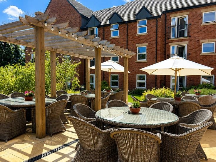 a patio with tables and chairs