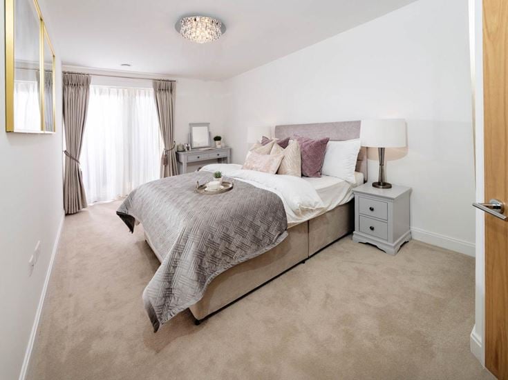 a bedroom with a bed and a lamp