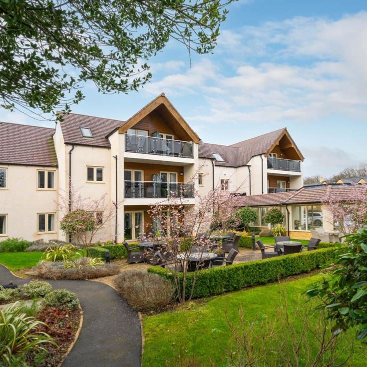 a large house with a garden in front of it