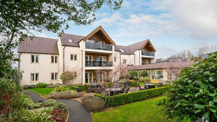 a large house with a garden in front of it