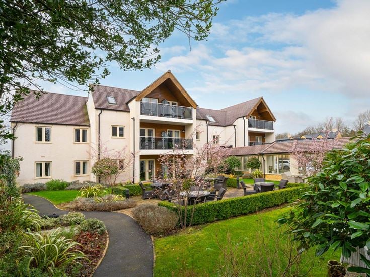 a large house with a garden in front of it
