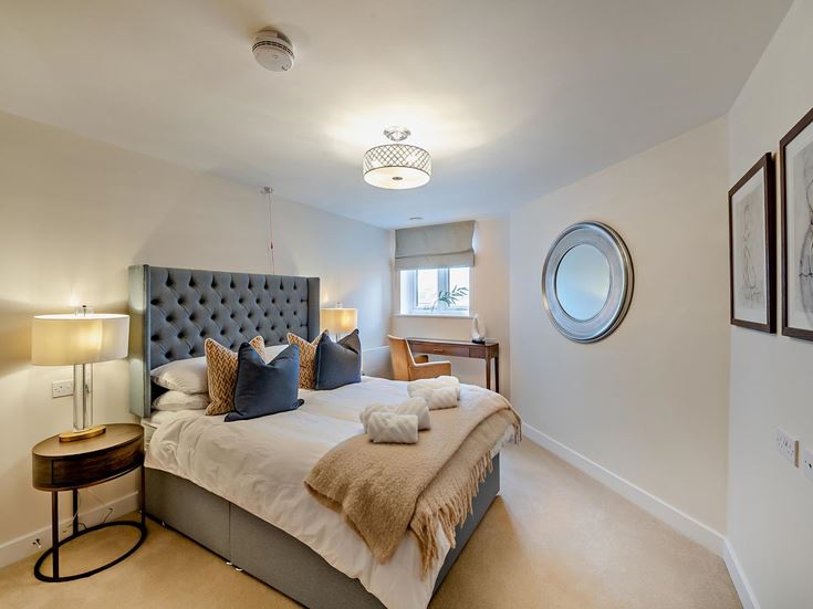 a bedroom with a bed and a mirror