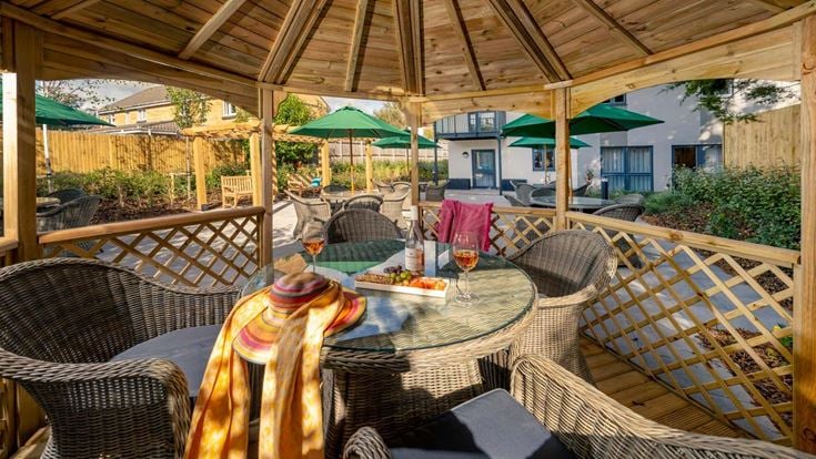 a patio with a table and chairs