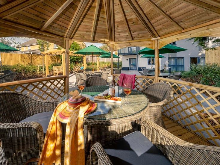 a patio with a table and chairs