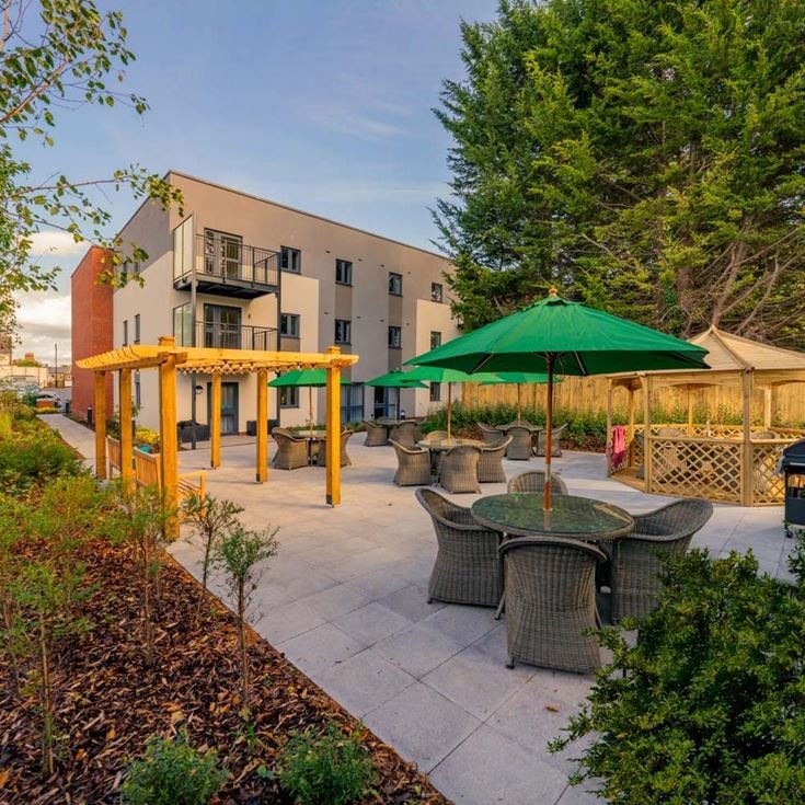 a patio with tables and chairs