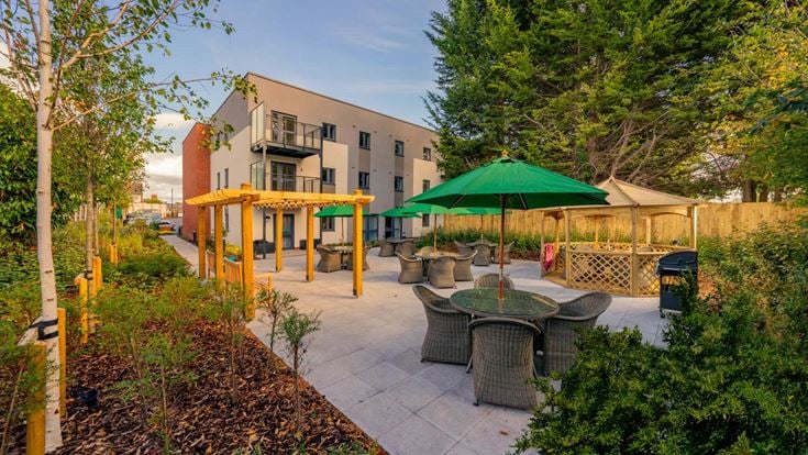 a patio with tables and chairs
