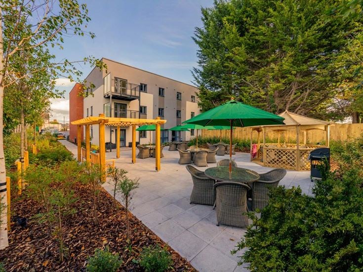 a patio with tables and chairs