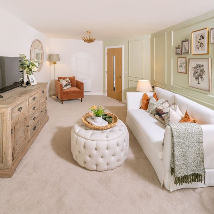 a living room with a white couch and a round coffee table