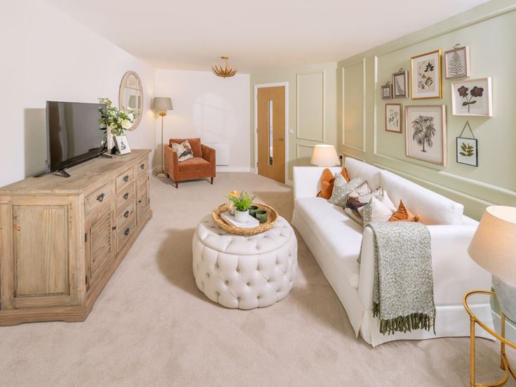 a living room with a white couch and a round coffee table