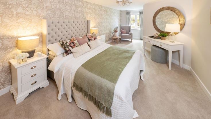a bedroom with a bed and a mirror
