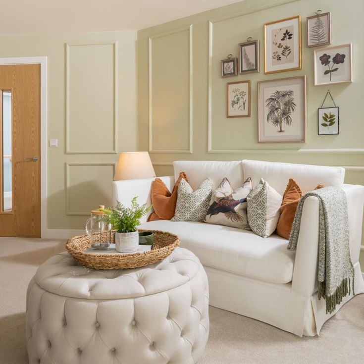 a living room with a white couch and a white chair