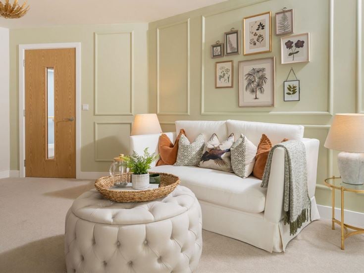 a living room with a white couch and a white chair