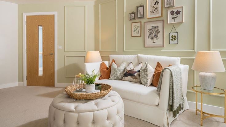 a living room with a white couch and a white chair
