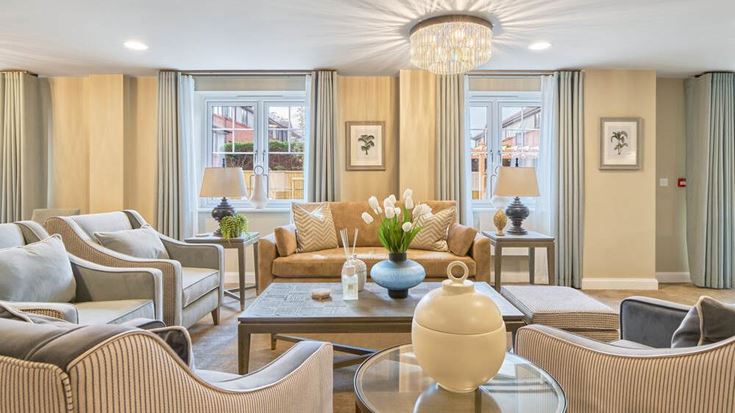 a living room with a large chandelier and a large glass table