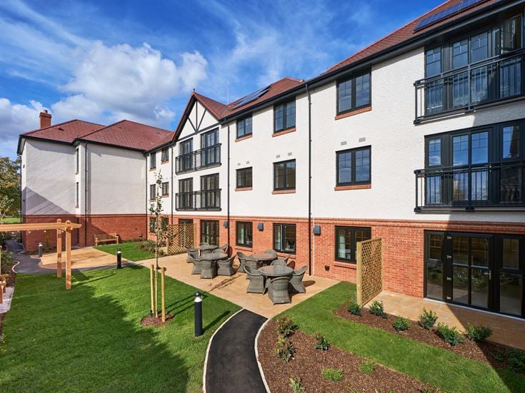 a building with a lawn and a playground in front of it