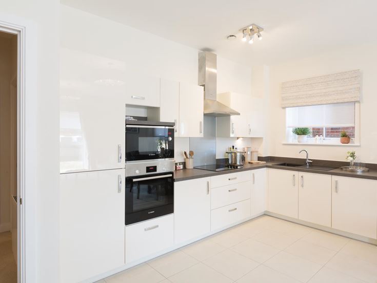 a kitchen with white cabinets