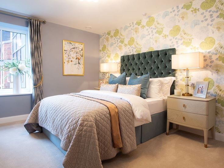 a bedroom with a bed and lamps