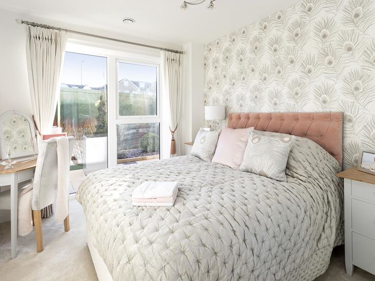 a bedroom with a bed and a desk