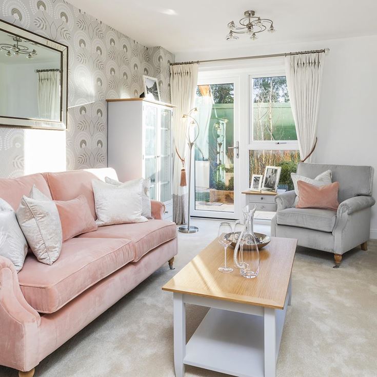 a living room with a pink couch