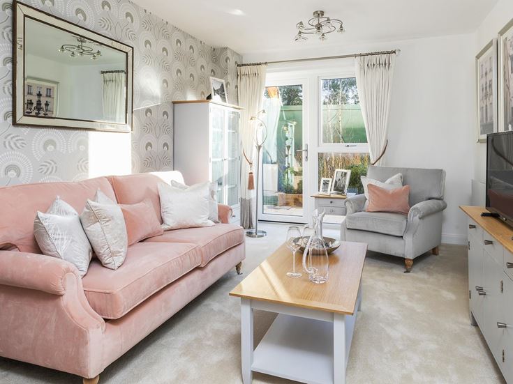 a living room with a pink couch
