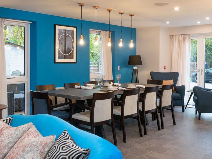 a dining room with a table and chairs