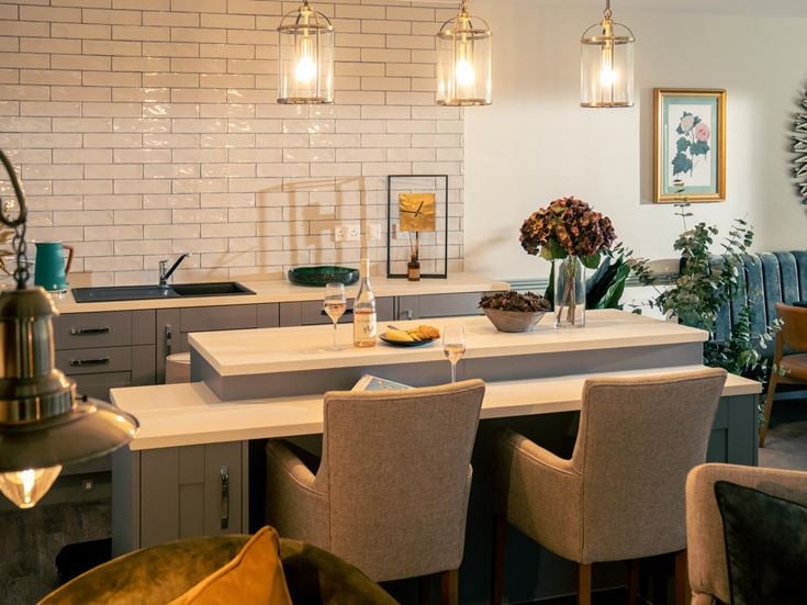 a dining table with a set of chairs and a lamp