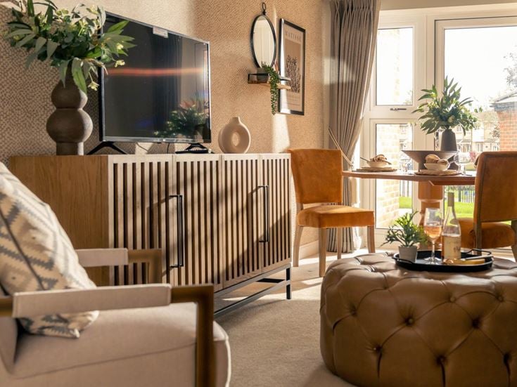 a living room with a couch and chairs