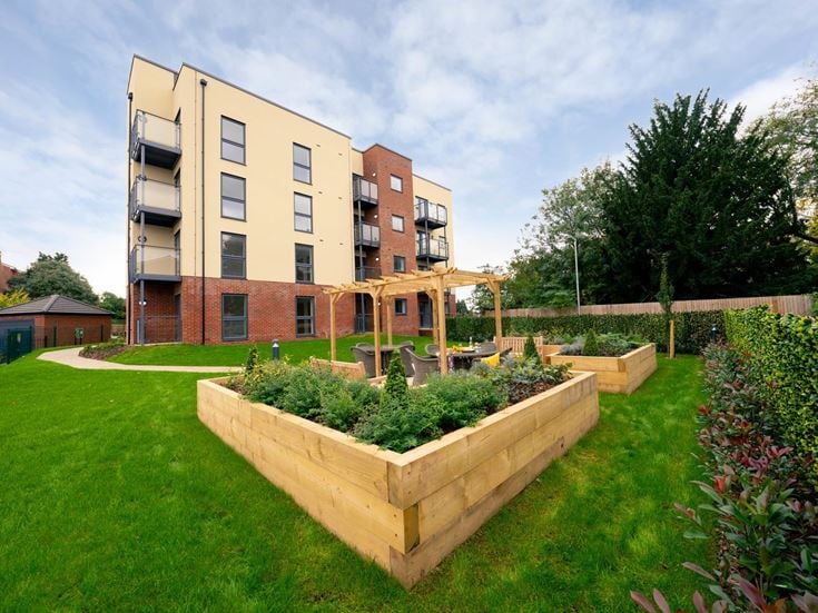 a large building with a garden in front of it