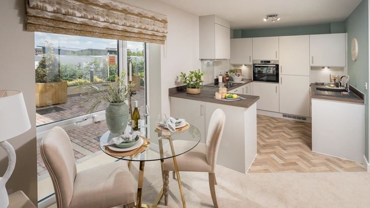 a kitchen with a table and chairs