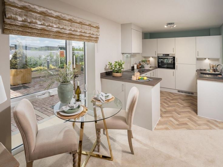 a kitchen with a table and chairs