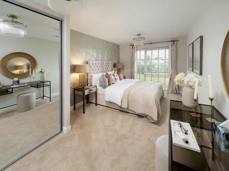 a bedroom with a bed and a desk