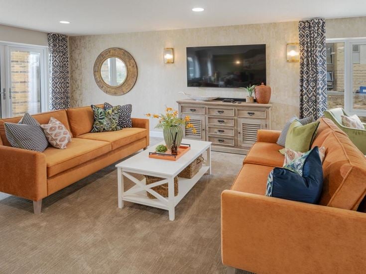 a living room with a tv and couches