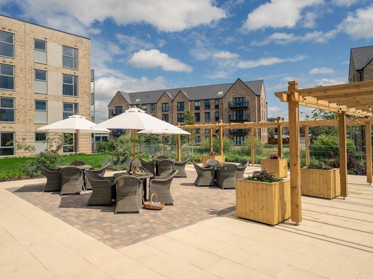 a patio with chairs and umbrellas