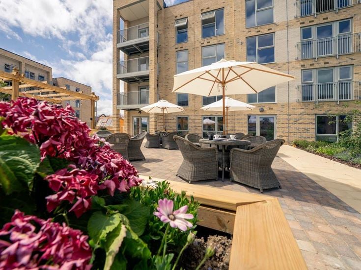 a patio with chairs and umbrellas