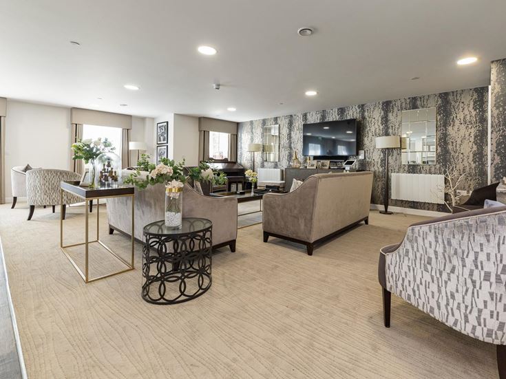 a large living room with a large dining table and couches