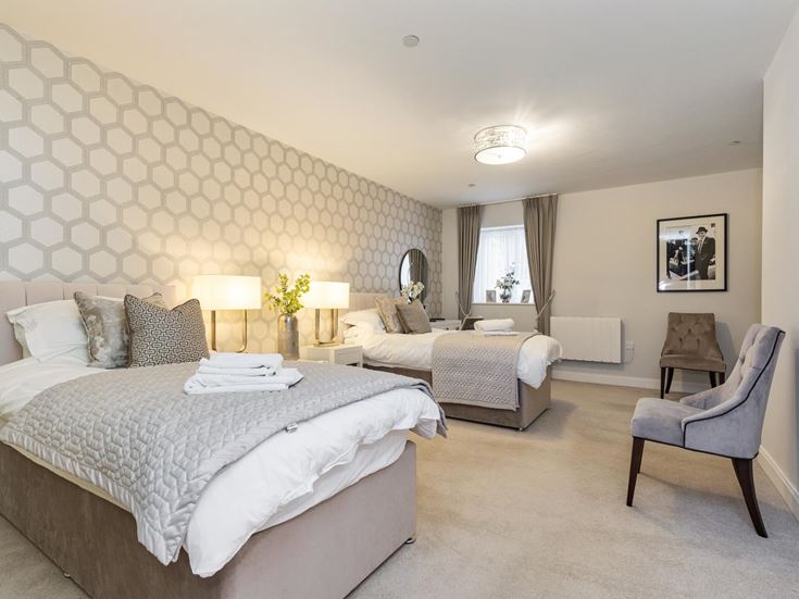 a bedroom with a bed and a chair