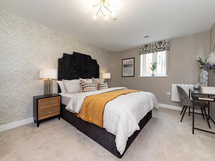 a bedroom with a bed and a desk