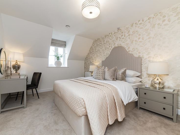 a bedroom with a bed and lamps