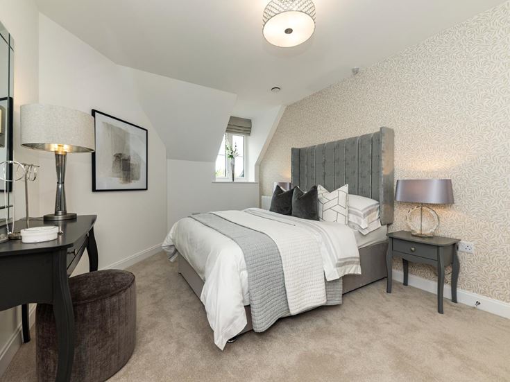 a bedroom with a bed and lamps
