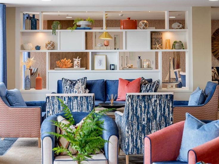 a living room with a couch and chairs
