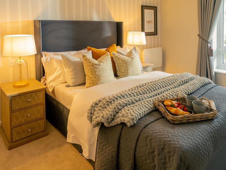 a bed with a basket of food on it