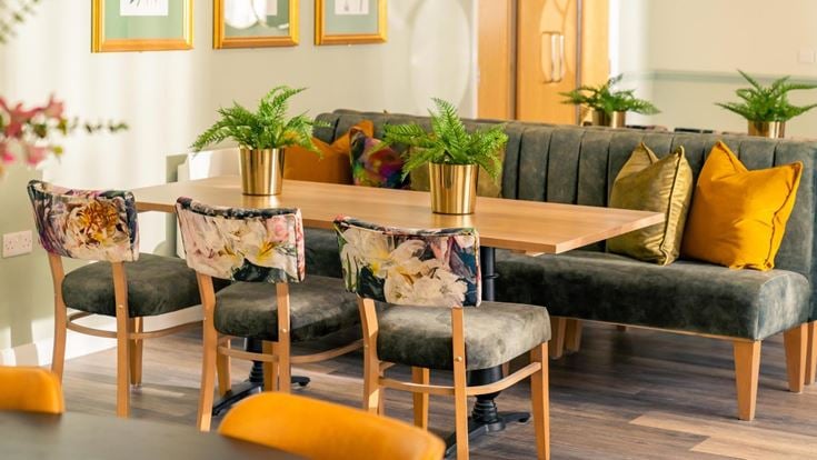 a living room with a couch and chairs