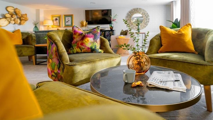 a living room with a coffee table and couches